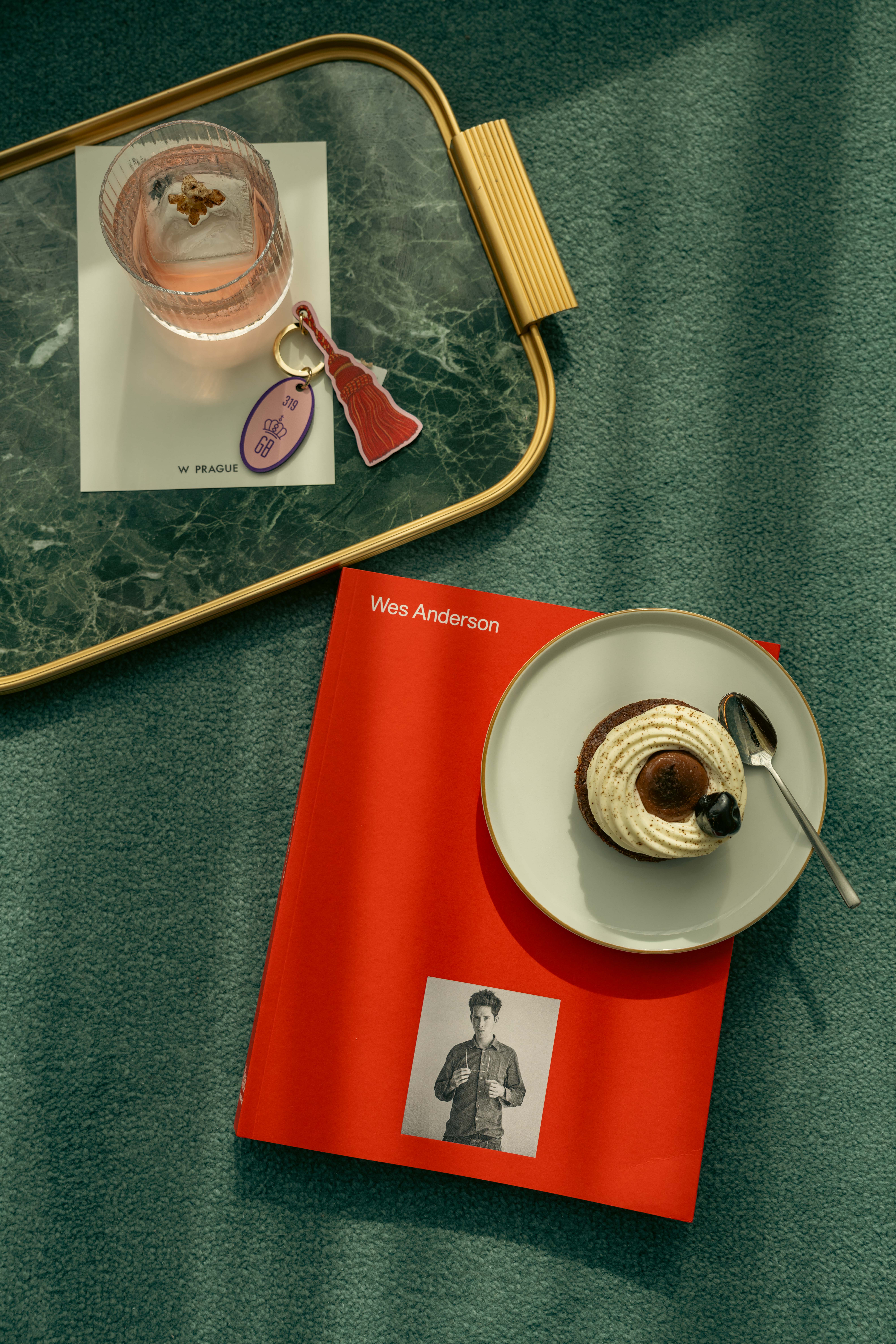 A Red book with a tray and a cocktail
