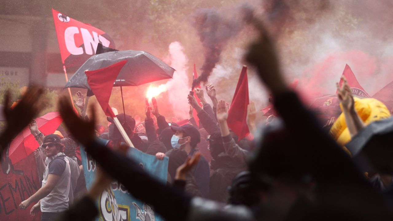 Demonstrators chant slogans and raise flares during an anti far-right rally in Nantes on 15 June