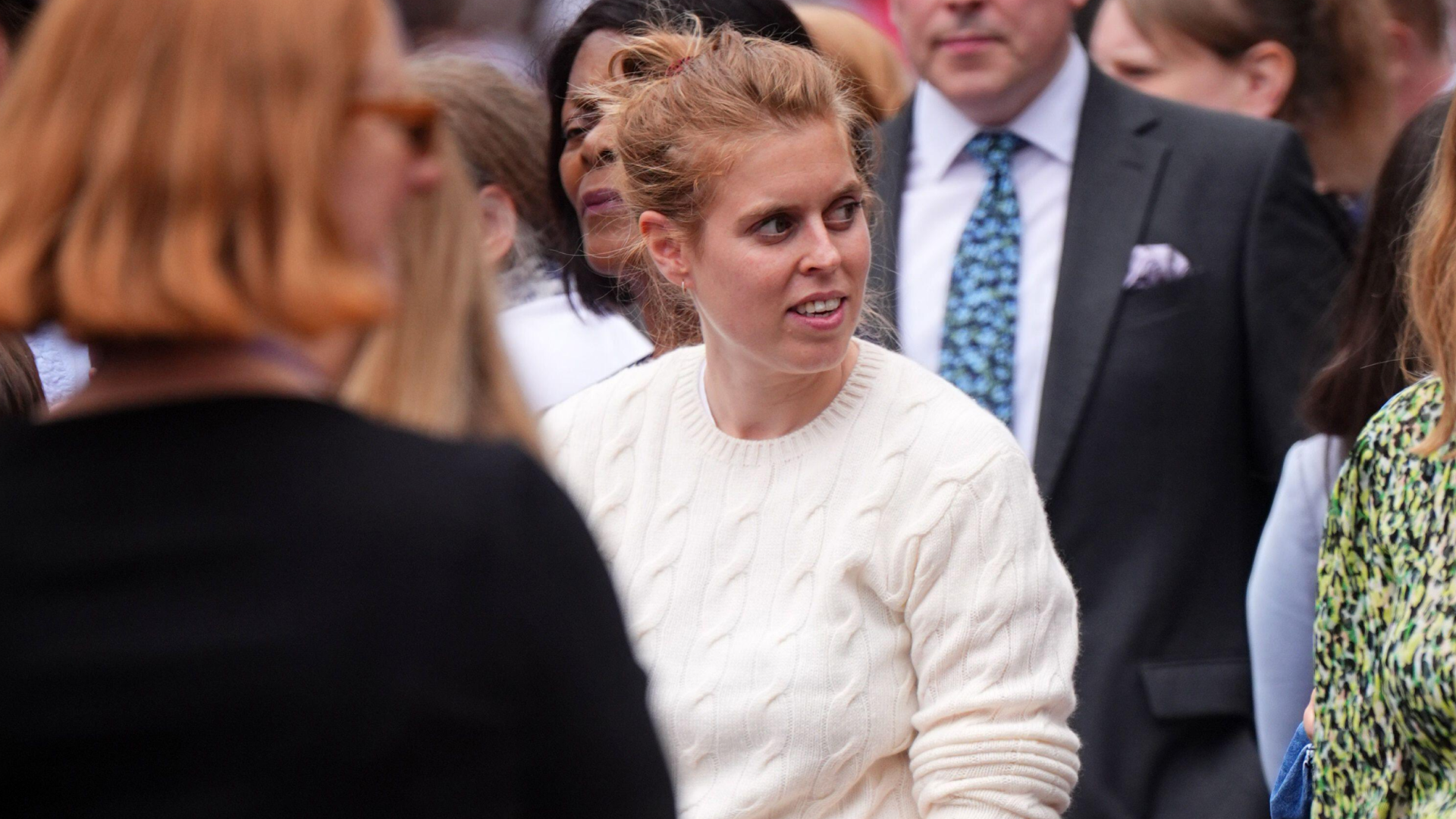 Princess Beatrice wearing a cream sweater in a crowd