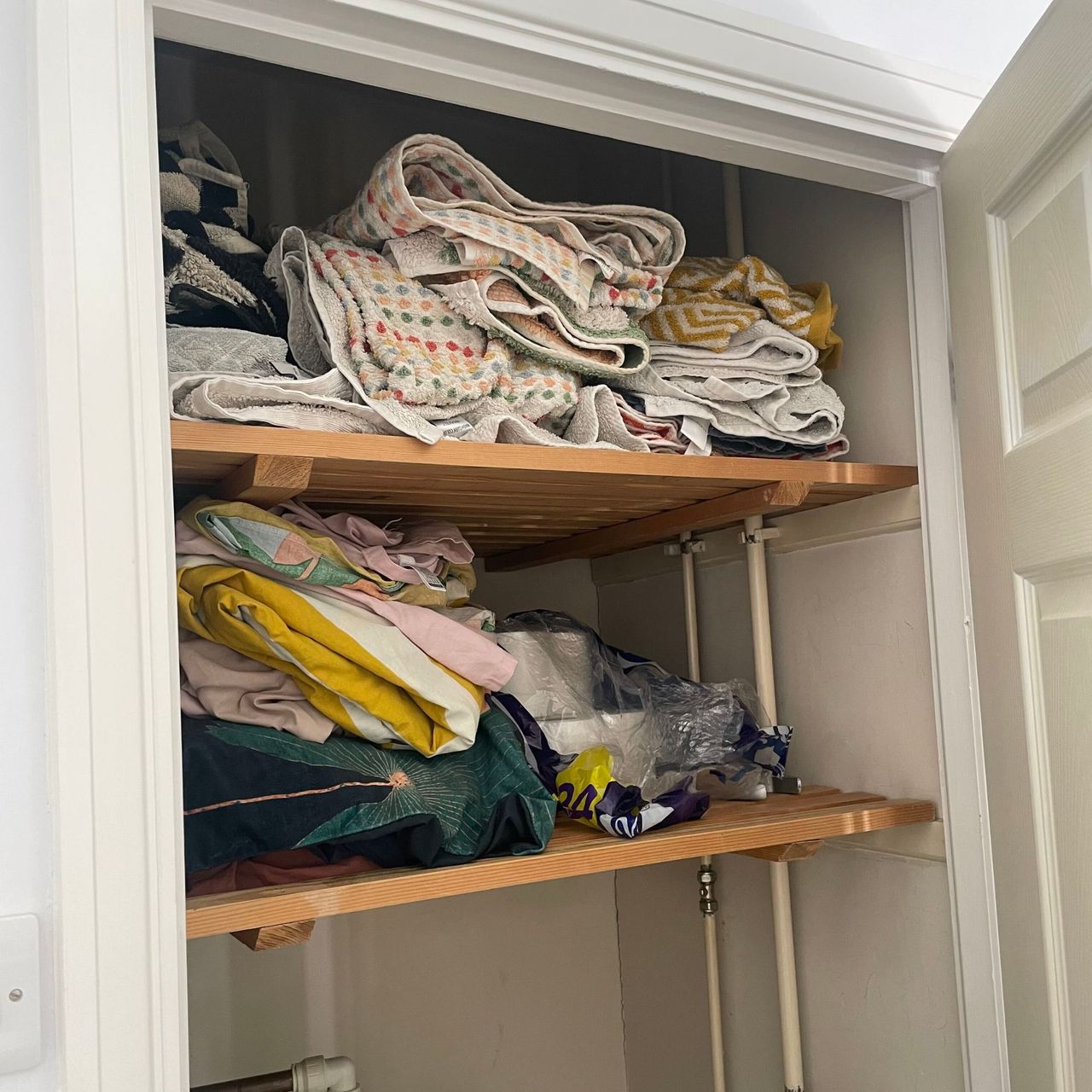 Airing cupboard filled with colourways bedding and towels