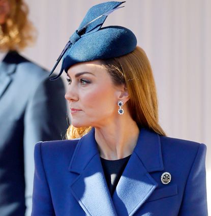 Kate Middleton wearing a blue coat and hat