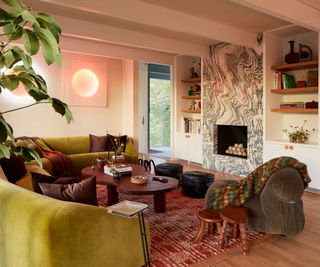 eclectic living room with green velvet curved couch and mismatched wooden furniture