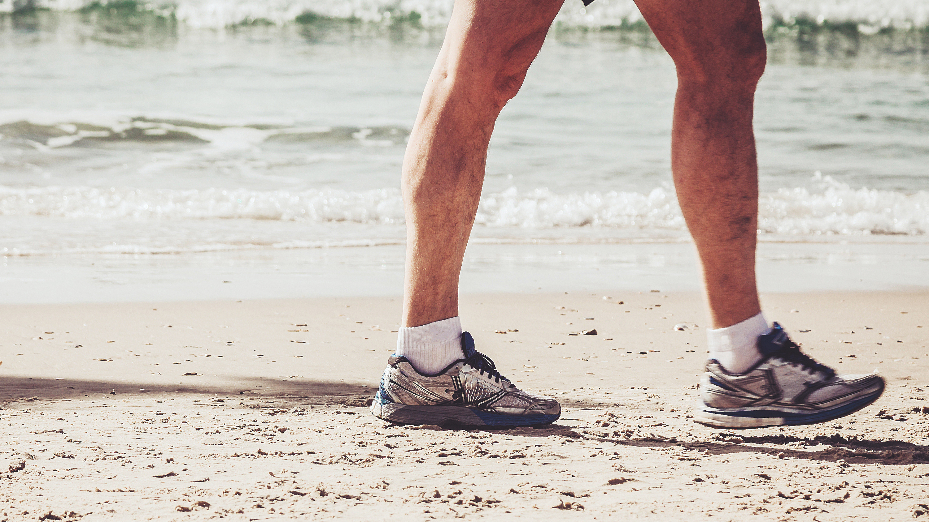 a man walking on a beach