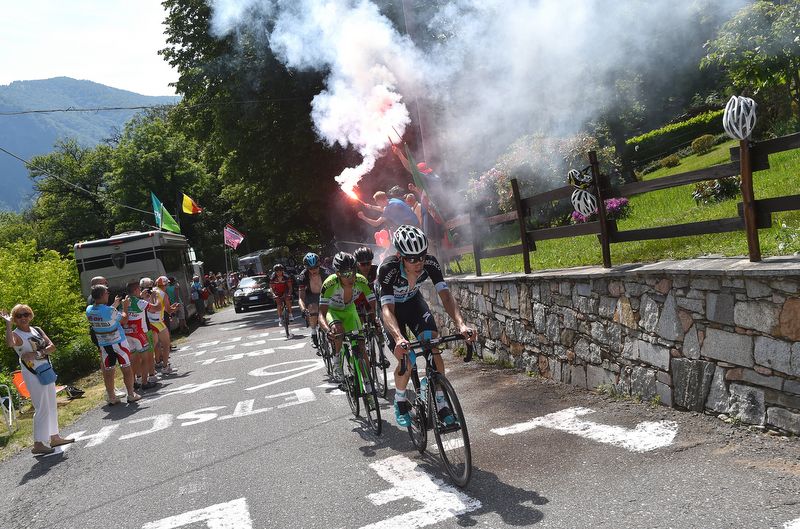 David de la Cruz (Etixx-Quick Step) leads the break past a fan with a flare