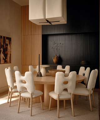modern dining area with round table and modern upholstered chairs