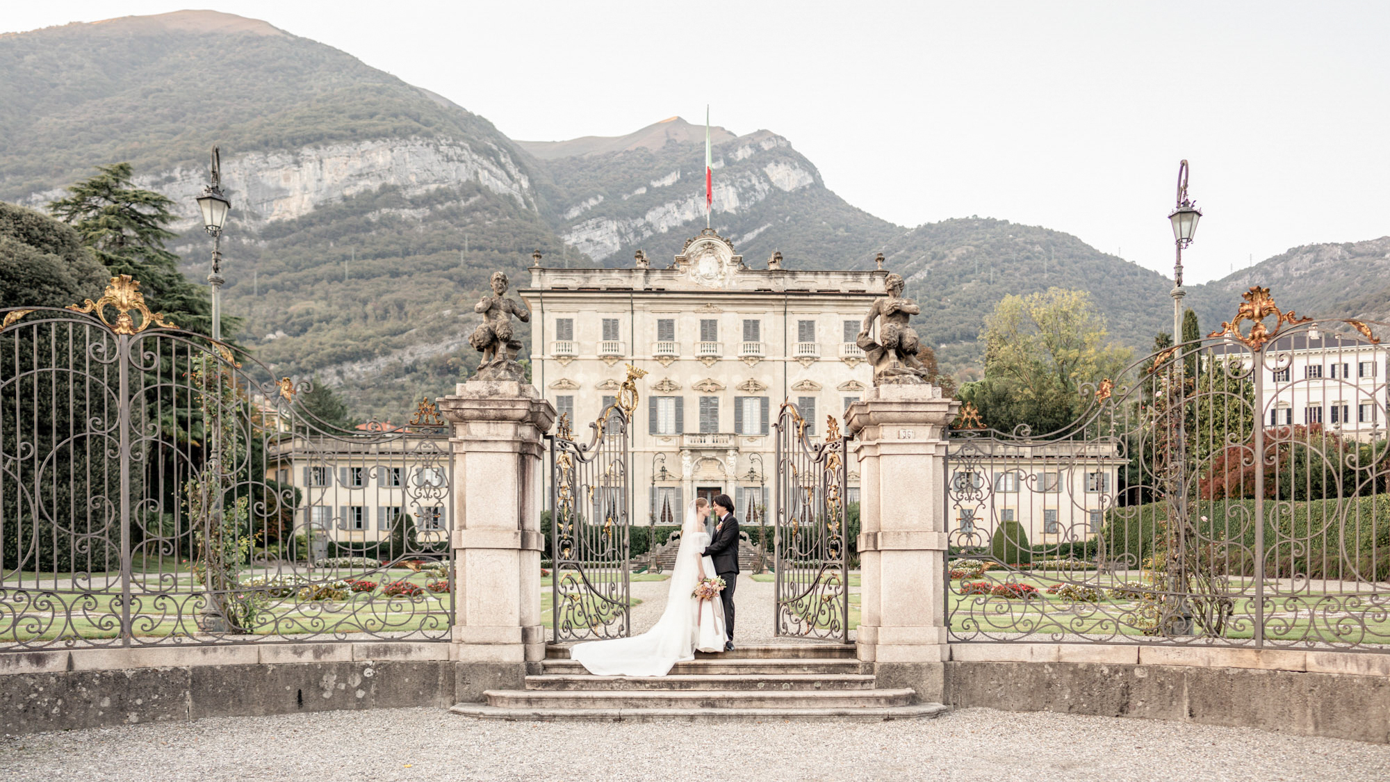 Bride and groom in front of mansion