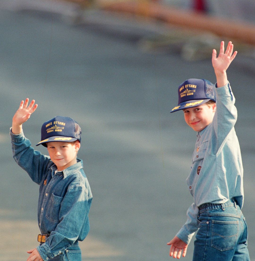 Prince William and Prince Harry waving in jeans and denim shirts