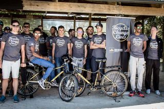The riders pose for a photo with the Qhubeka Buffalo Bikes