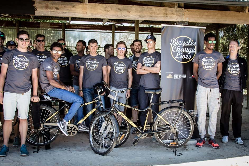 The riders pose for a photo with the Qhubeka Buffalo Bikes