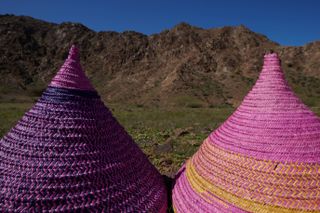 woven conical purple food covers in natural landscape