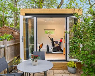 A garden room repurposed as a home gym