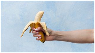 Close-Up Of Man Holding Banana