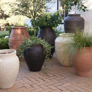 Sienna Fiber Stone Outdoor Planters on a patio.