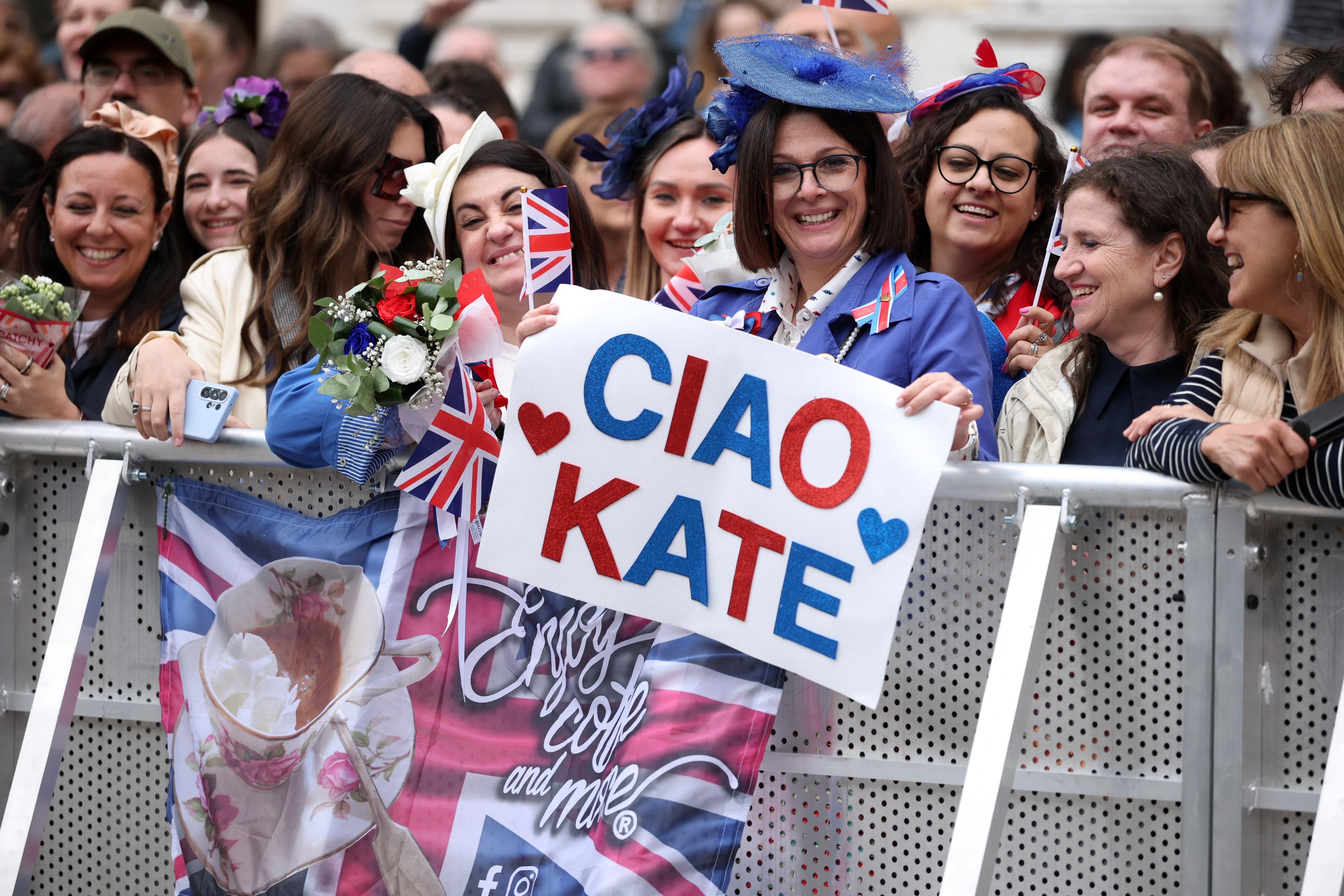 Fans holding a sign that says Ciao Kate