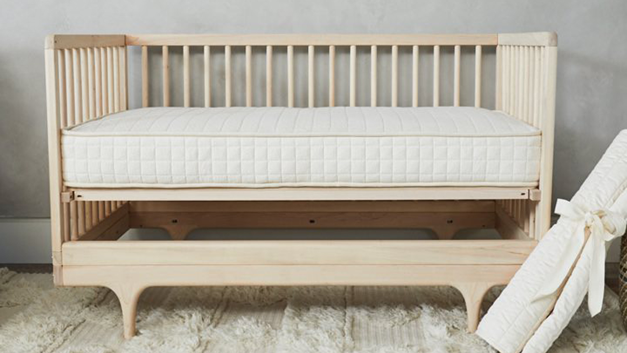 Avocado mattress sales, discounts and promo codes: the luxe version of the Avocado Crib Mattress show in a light wooden frame