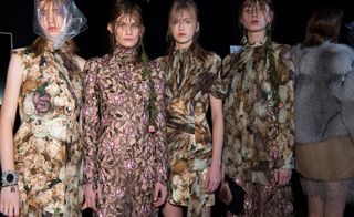 4 female models in neutral floral clothing pose for the camera