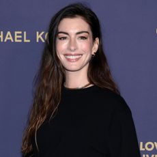 Anne Hathaway arrived at the 2025 Golden Heart Awards wearing all-black Michael Kors, plus the skirt over pants trend