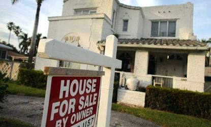 A "for sale" sign is posted in front of a house Hollywood, Fla.
