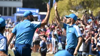 Nicolai Hojgaard high-fives playing partner Jon Rahm after making birdie on the first at Marco Simone