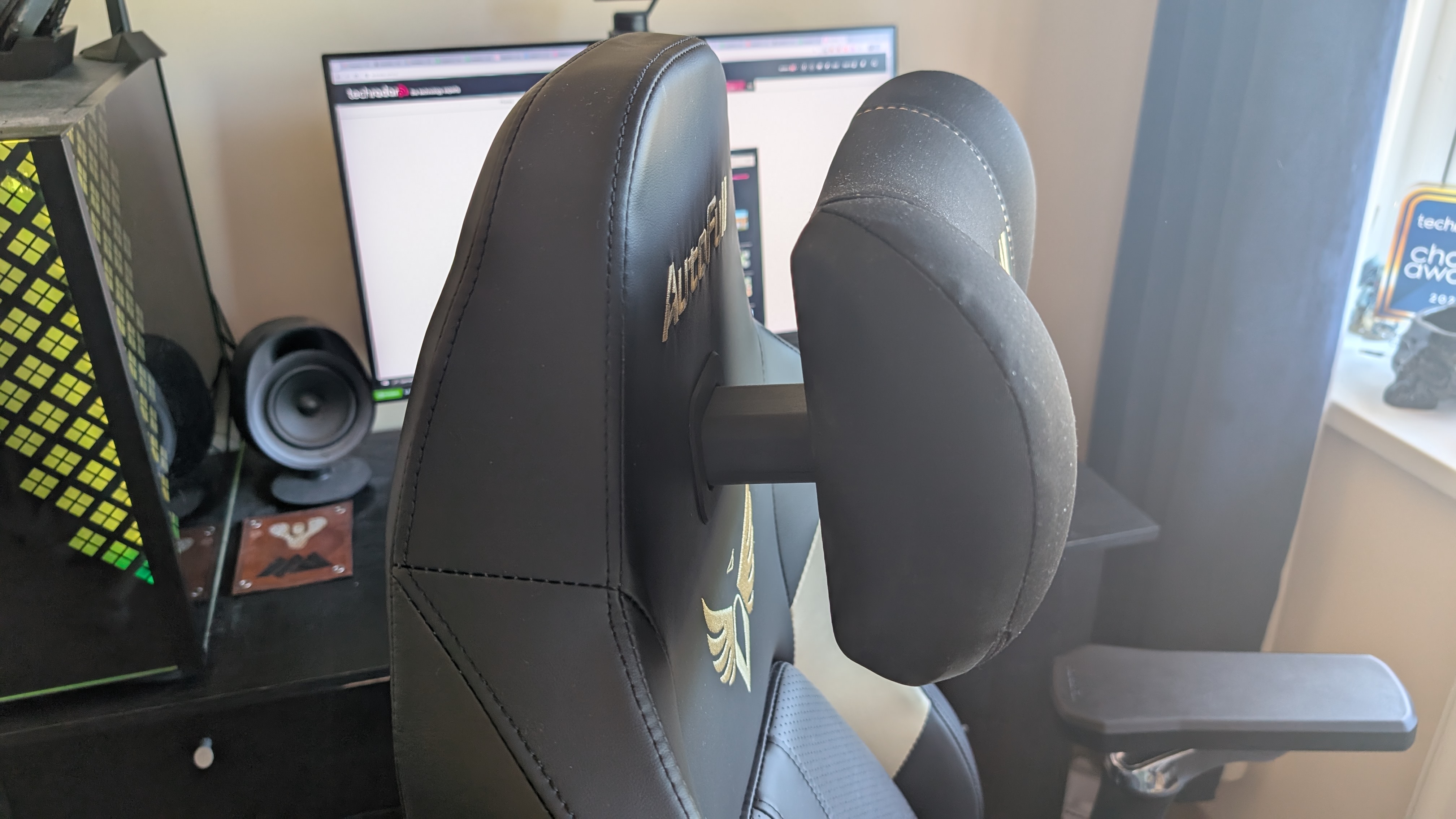 The AutoFull M6 Ultra gaming chair pictured in front of a desk with a gaming PC setup.