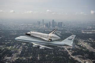 Space Shuttle Endeavour is ferried by NASA's Shuttle Carrier Aircraft (SCA) over Houston, Texas on September 19, 2012.
