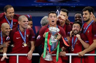 Cristiano Ronaldo celebrates with the European championship trophy alongside his Portugal team-mates after victory over France in the final of Euro 2016.