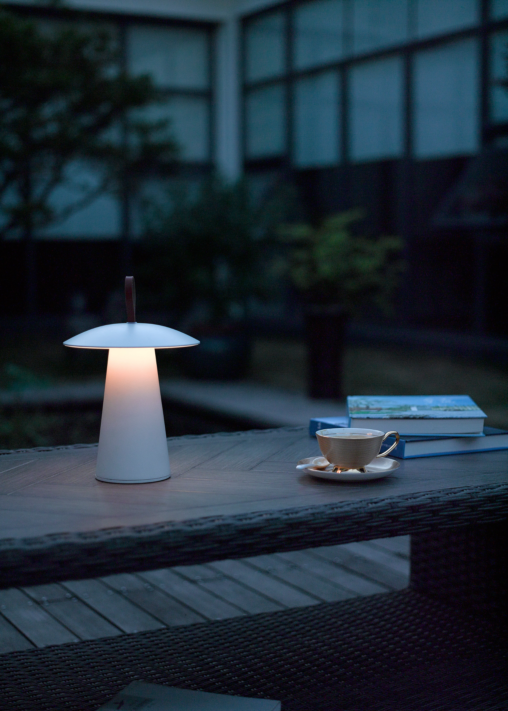 A solar -powered outer lamp in white on a garden table
