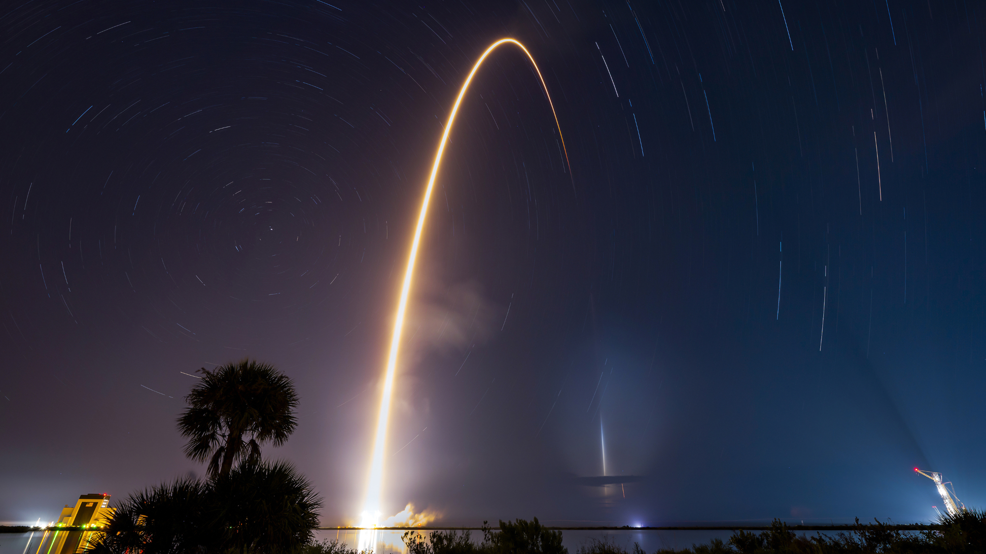 A bright arc streaks through the night sky