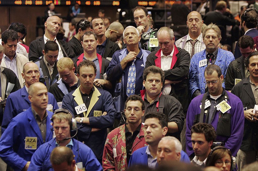Traders in the soybean pit at the Chicago Board of Trade observe a moment of silence before the opening bell to mark the anniversary of the attacks on the World Trade Center on September 11, 2006.
