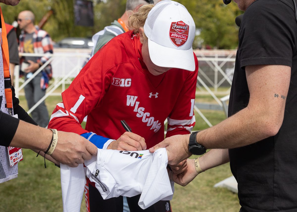 Fem Van Empel (Pauwels Sauzen - Bingoal) autographs the UCI leaders jersey while wearing the commerative University Wisconsin Badger hockey sweater that is given to the winner of each professional race at the Trek World Cup.
