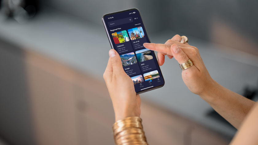 A person using the Nomad eSIM UI on their mobile phone.