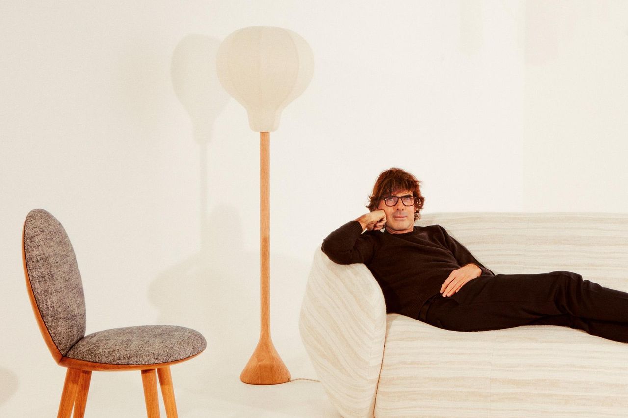 Designer Pierre Yovanovitch photographed in Paris in March 2021 with a ‘Clam’ chair, ‘Flare’ lamp and ‘Asymmetry’ sofa, all part of the Pierre Yovanovitch Mobilier launch collection