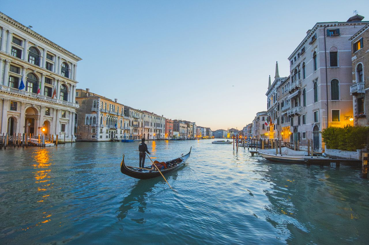 A gondolier on a peaceful canal in Venice, Italy.