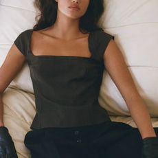 A model wearing a black square-neck top from St. Agni.