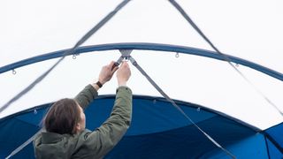 Air tents vs pole tents: tension straps being adjusted