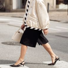 woman in shorts and kitten heels crossing the street