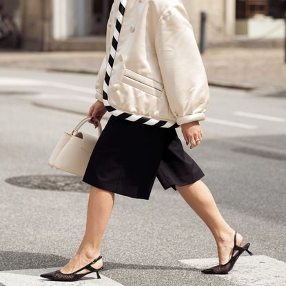 woman in shorts and kitten heels crossing the street