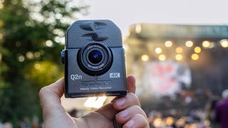 The Zoom Q2N-4K held in female hands at a summer festival