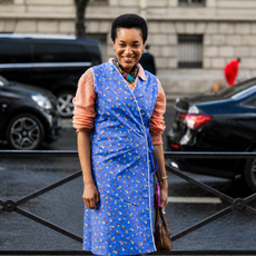 woman wearing apron dresses outside of show