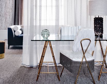 living room with modern chairs and white sheer curtain