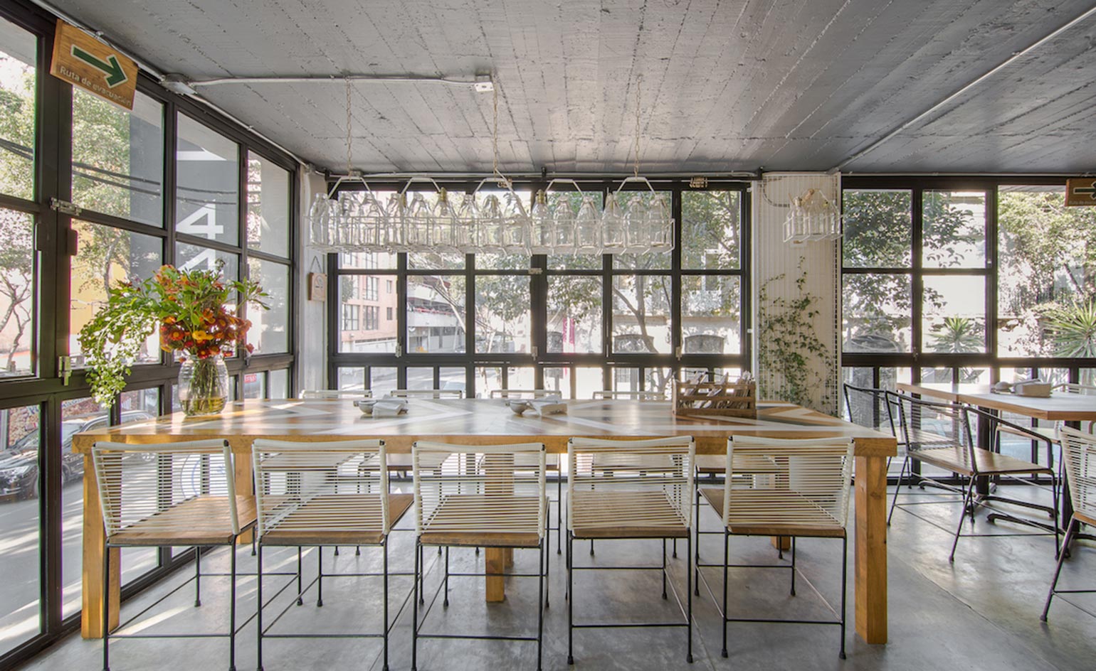Table and chairs with empty bottles hanging from above
