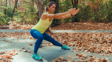 Woman doing side lunges outside