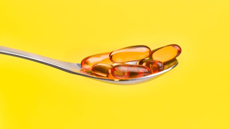 omega 3 tablets on a spoon