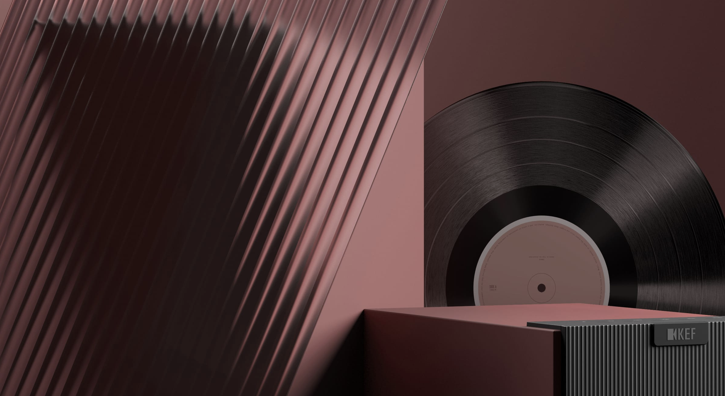 KEF teaser image showing the top of a speaker and a vinyl record