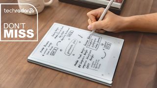 A person writing on the ViWoods AiPaper productivity tablet with a TechRadar deals inset saying "don't miss"