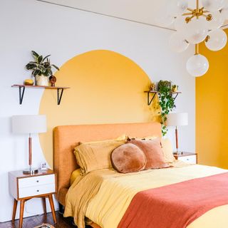 bedroom with orange headboard and floating shelves