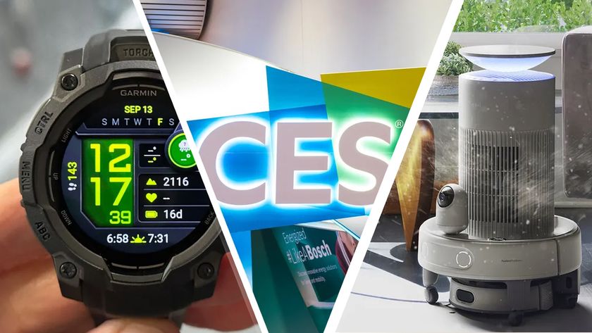 A hand holding a Garmin watch next to the CES logo and a Switchbot robot vacuum