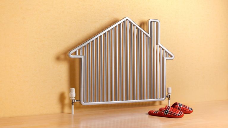 House shaped radiator with slippers—stock photo.