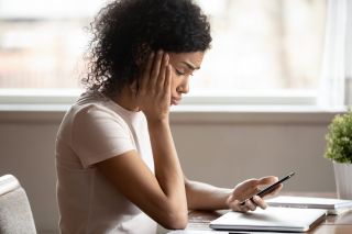 woman pouted lips looking at smartphone frustrated by received sms or notification, bad news reading on cell phone feels upset, waiting message from boyfriend, negative response concept.