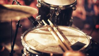 Snare drum with microphone, woman playing drums